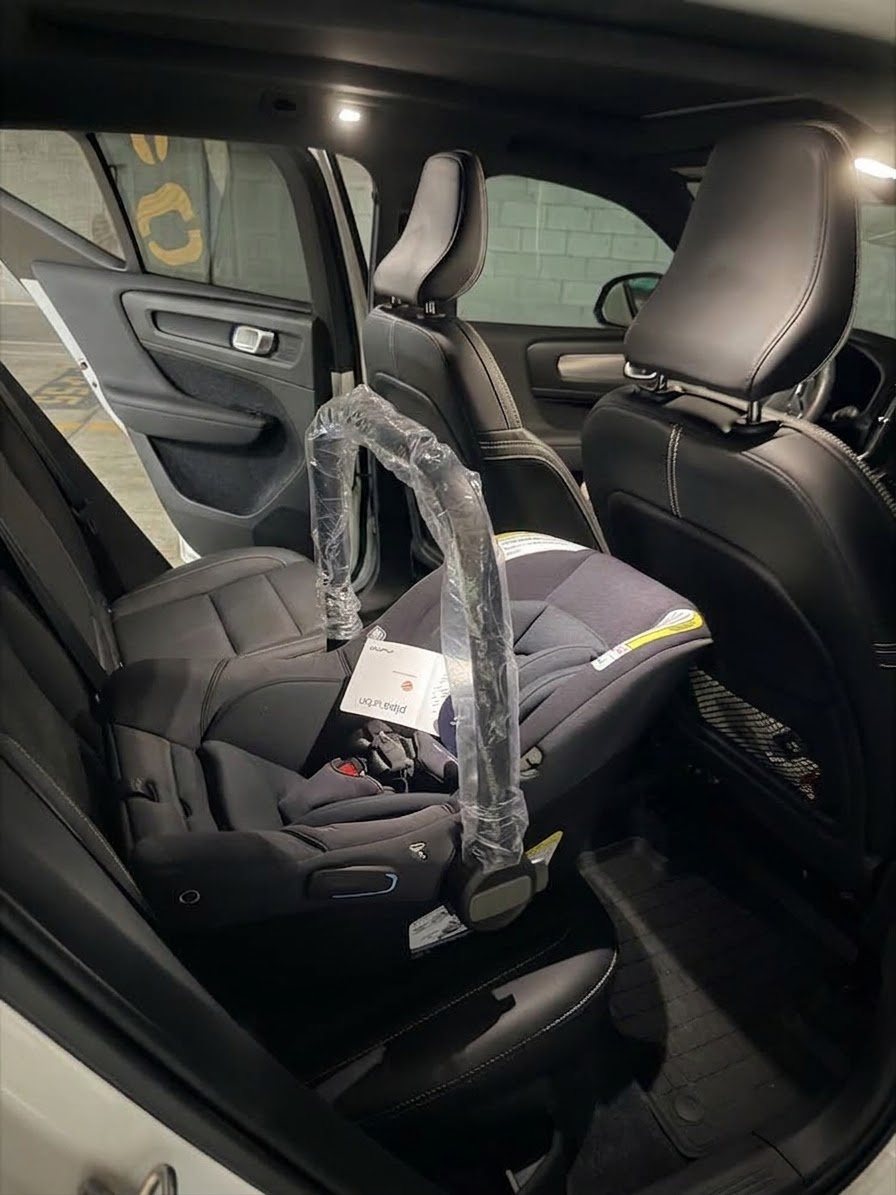Infant car seat installed in the back seat