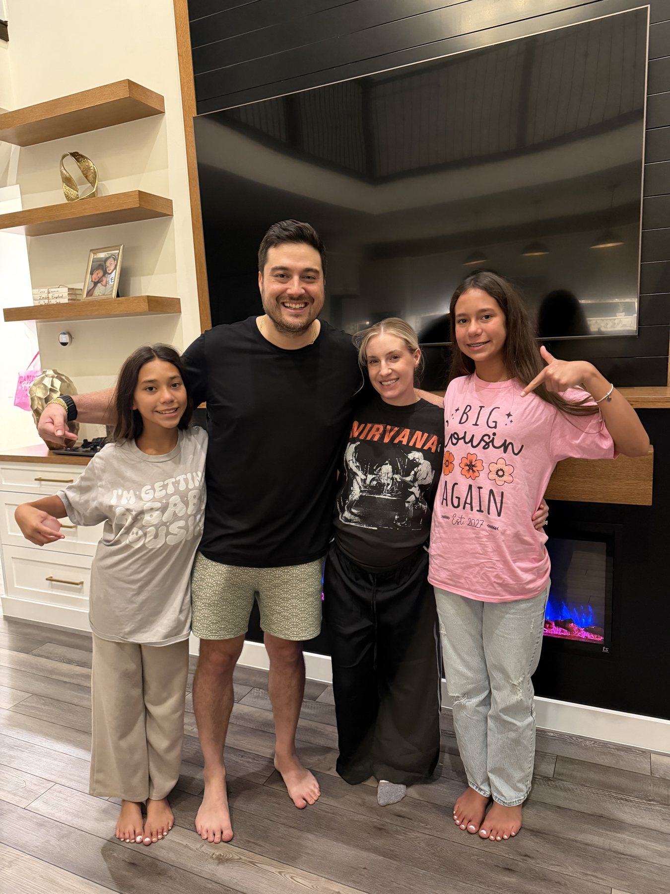 Vince and Andrea with the big cousins in their announcement shirts